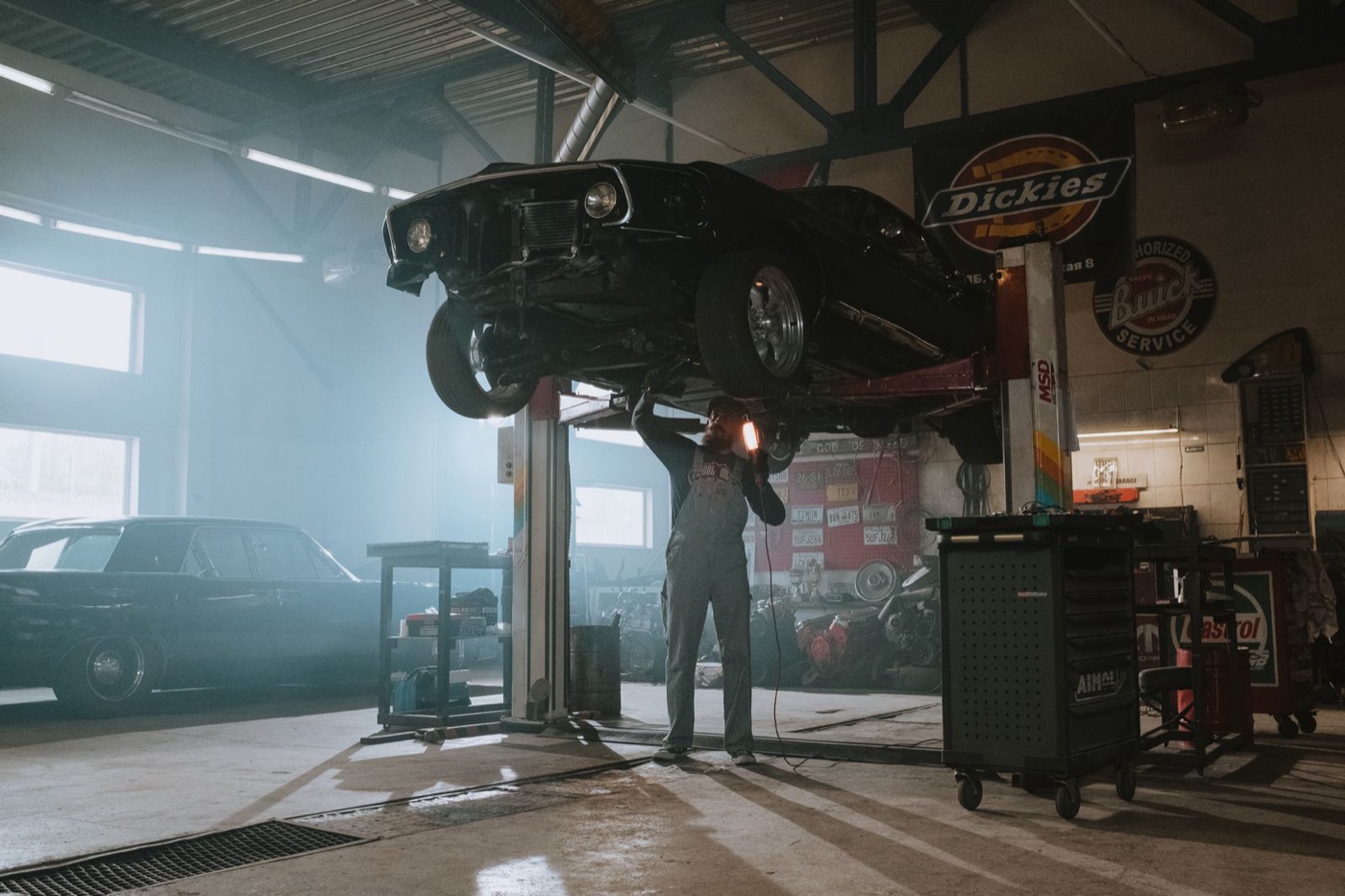 Classic vehicle raised on a lift in the build shop